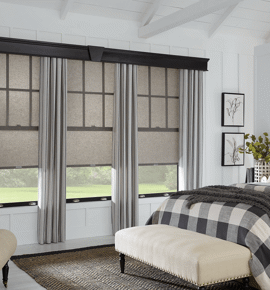 Grey drapes in a bedroom complete with cellular shades Photo